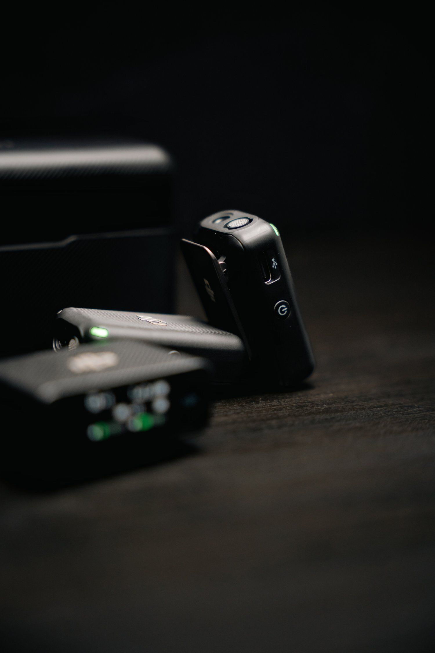 Close-up of electronic device controls with LED indicator in dark setting.
