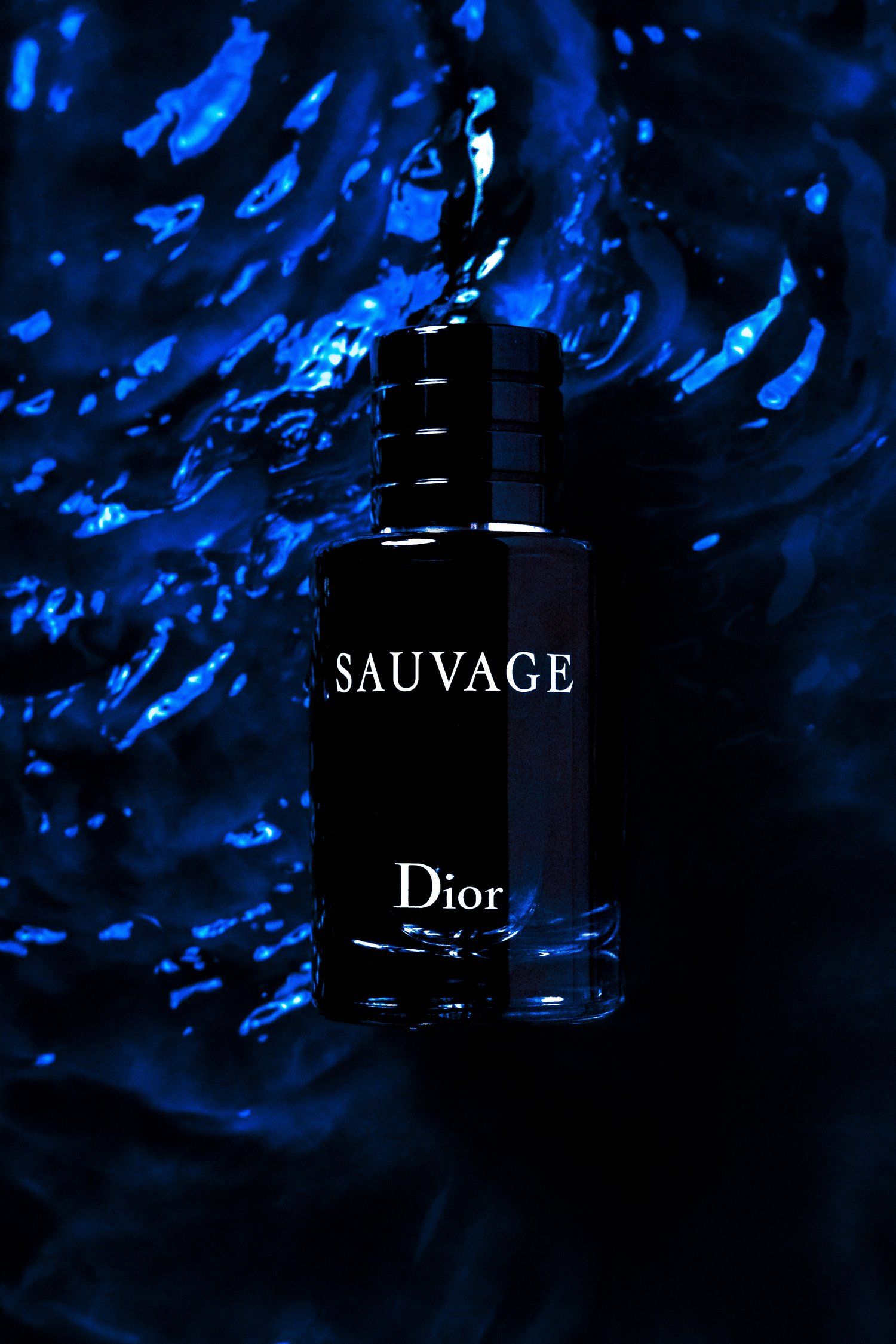 Dior Sauvage fragrance bottle against dramatic blue water-like background.