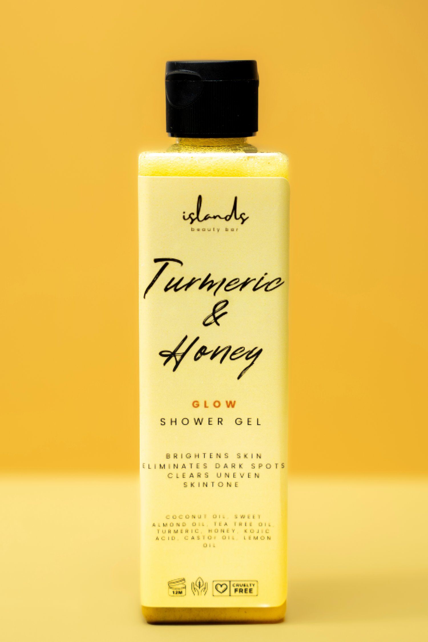 Yellow bottle of Turmeric & Honey glow shower gel against yellow background.