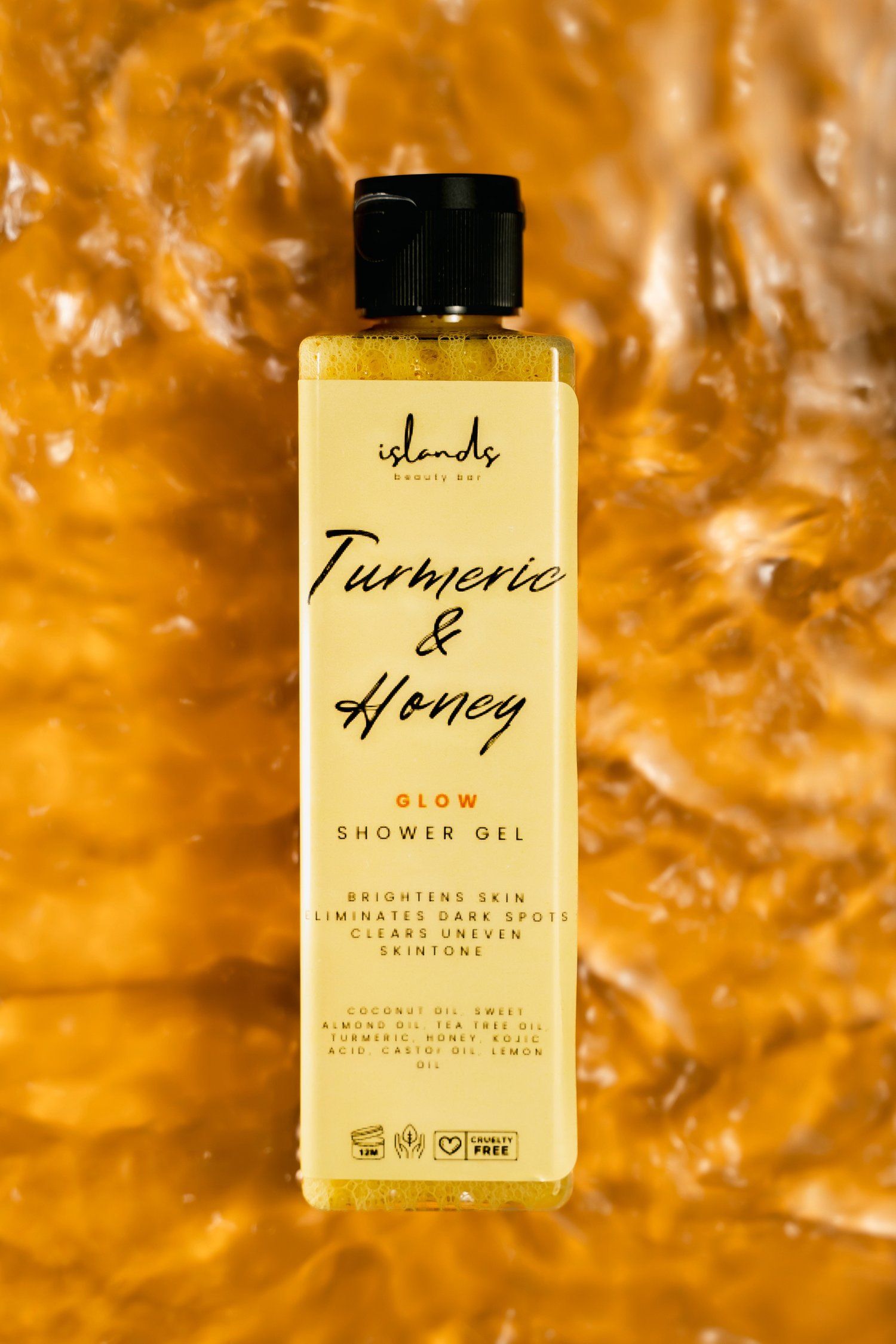 Turmeric and honey shower gel bottle photographed against golden textured background.