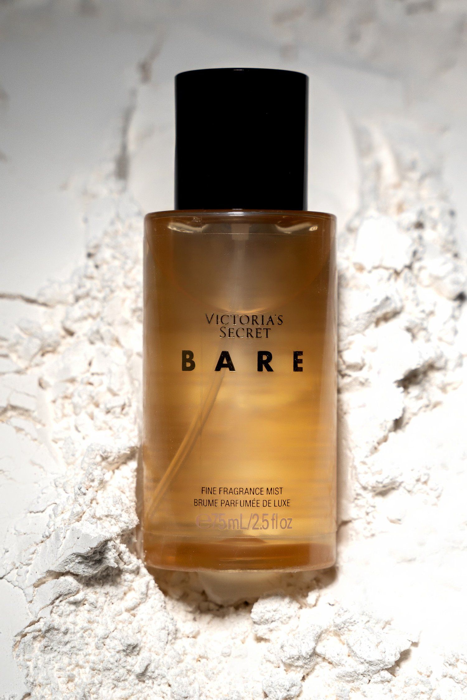 Victoria's Secret Bare fragrance mist bottle photographed on textured white surface.