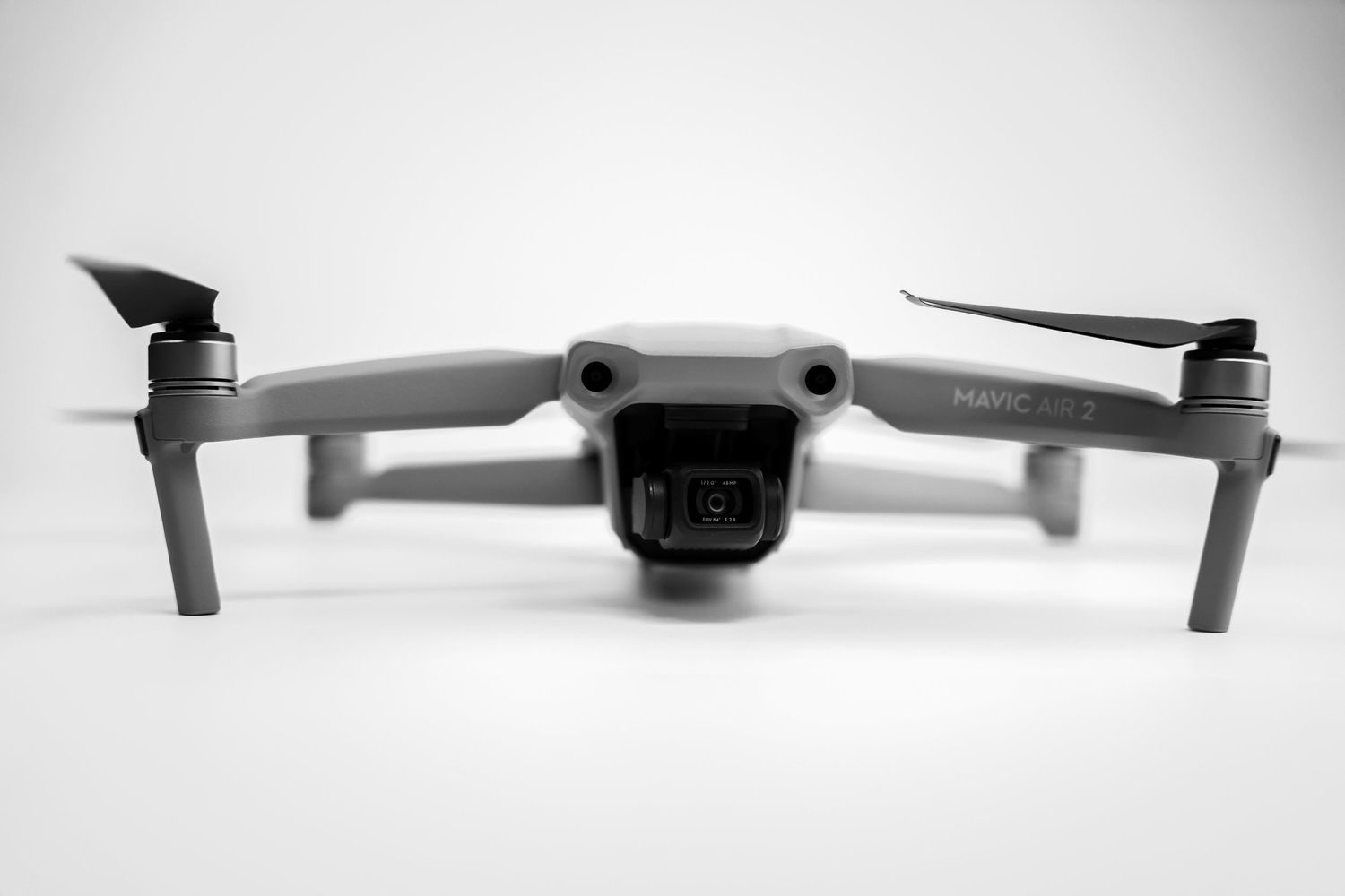DJI Mavic drone shown in black and white photography with extended arms and camera gimbal.