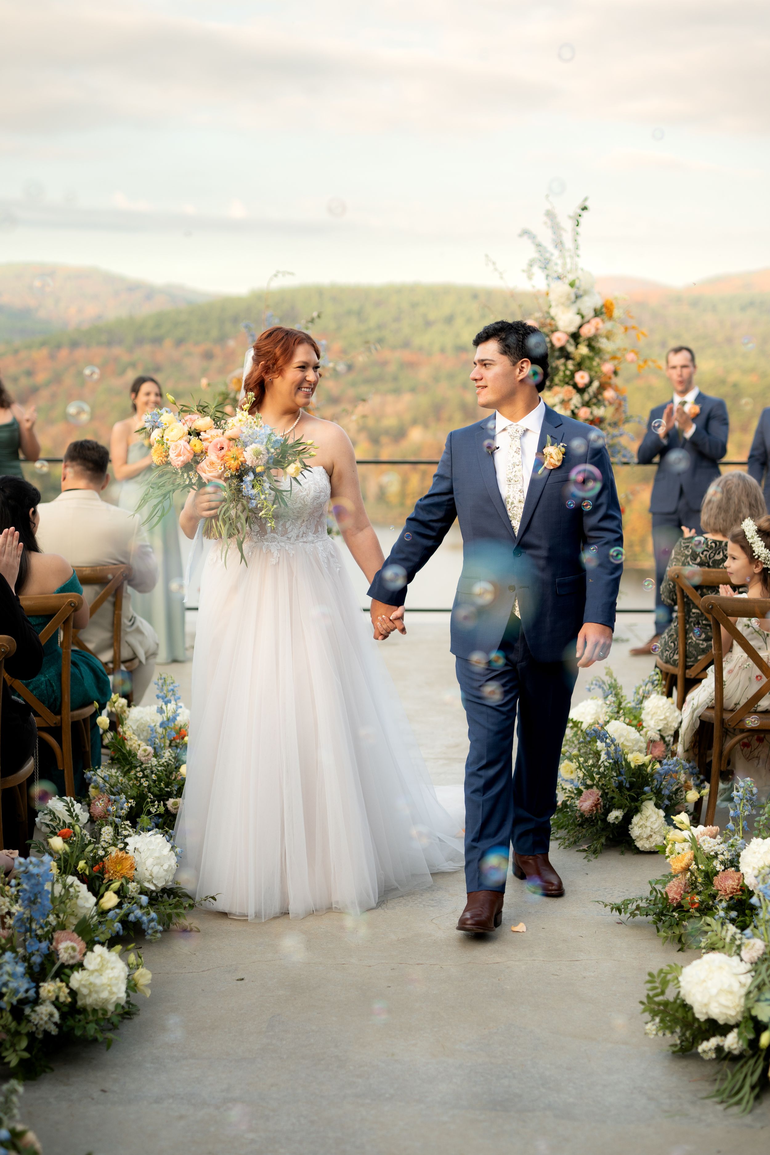 Wedding ceremony setup with elegant floral arrangements and mountain views.