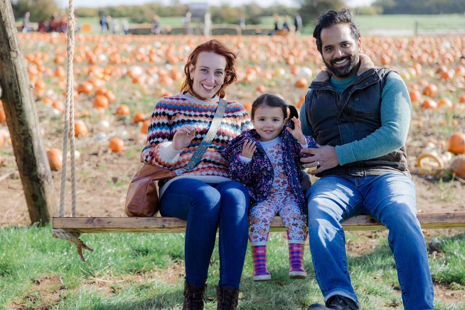 Family sitting together on bench at pumpkin patch.  Photographer. Hull. East Yorkshire. Photography