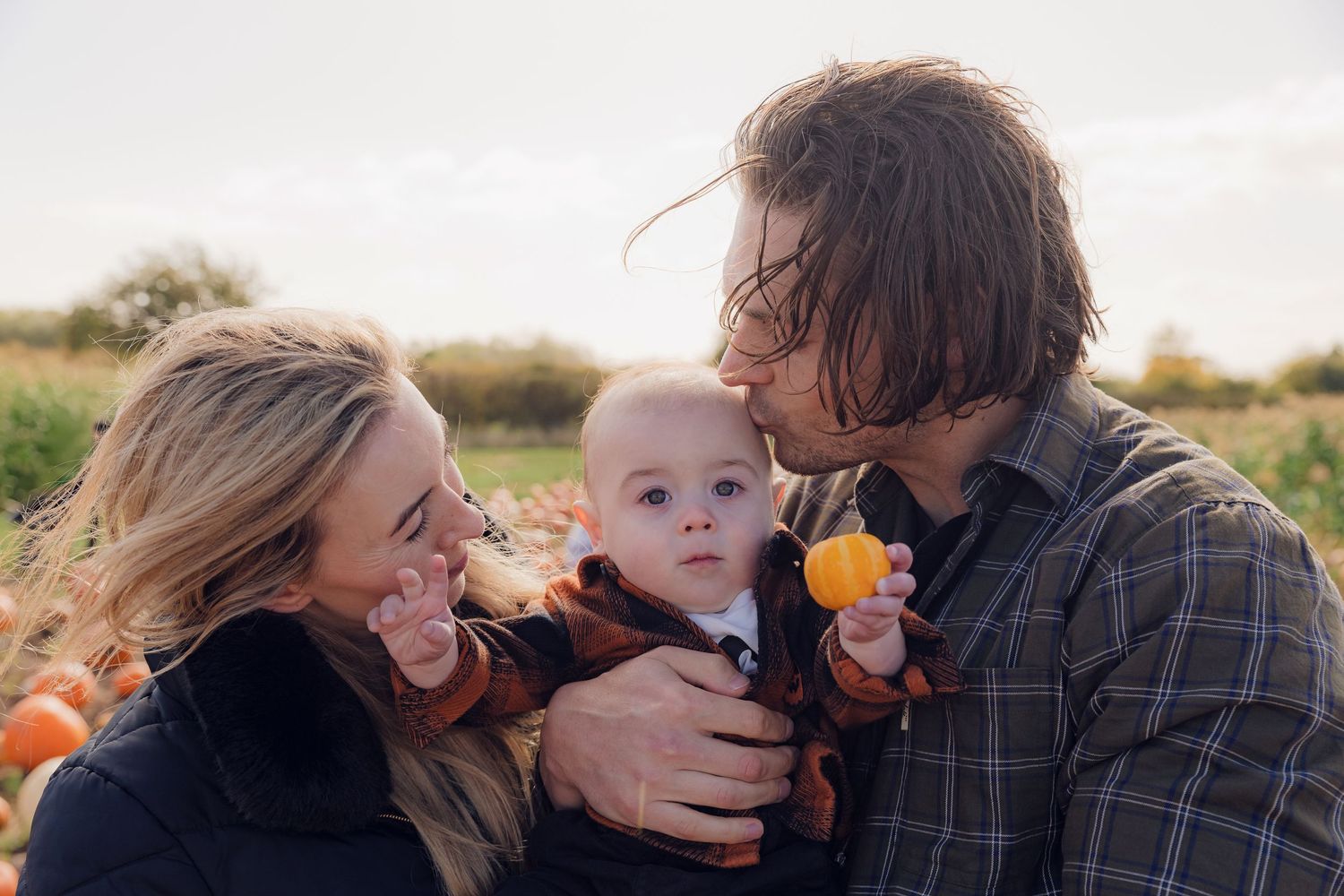 Sweet candid moments of parents with their baby during a golden hour photo session. Photographer. Hull. East Yorkshire.