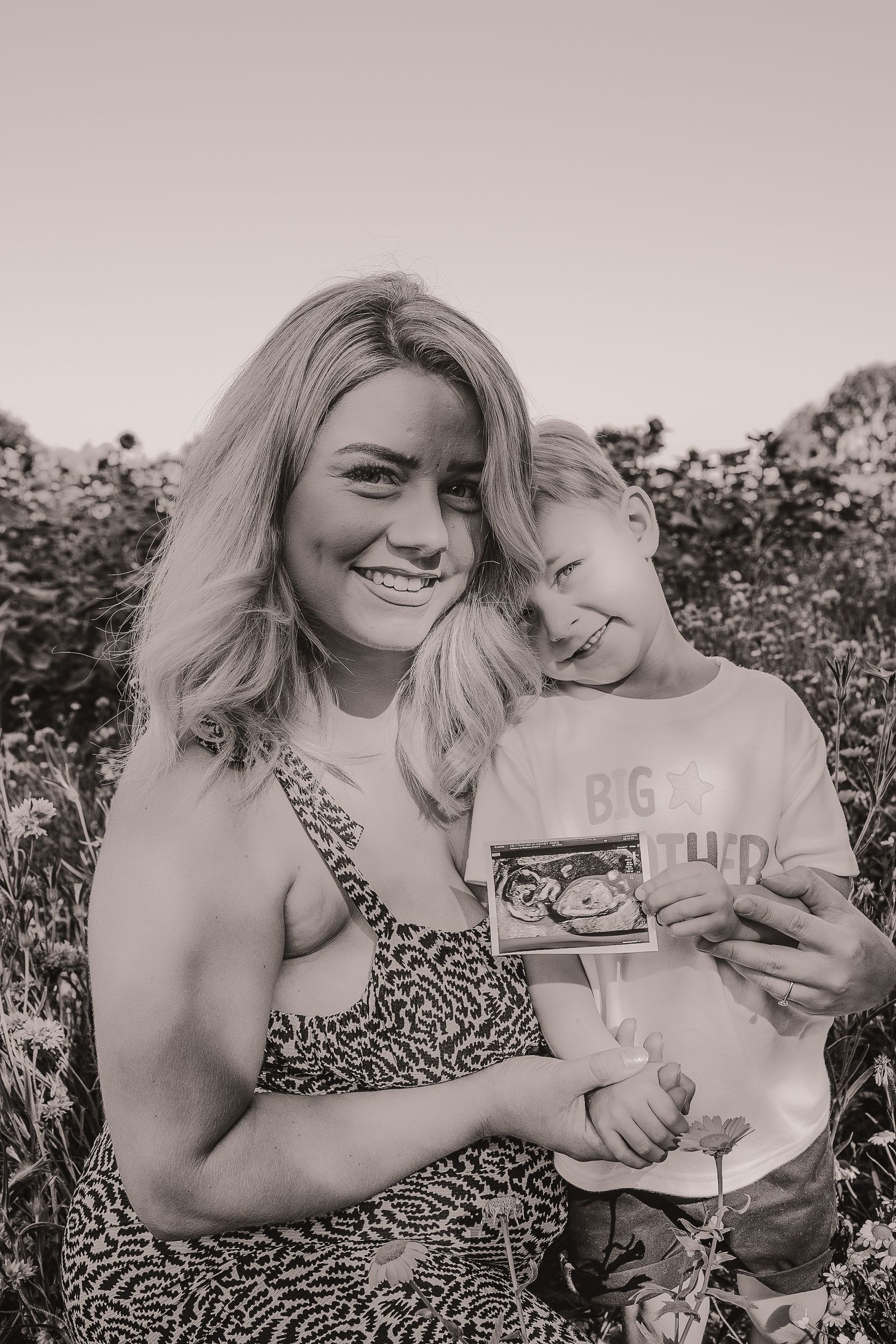 Mother and child sharing a joyful moment in a sunlit field.  Photographer. Hull. East Yorkshire. Photography