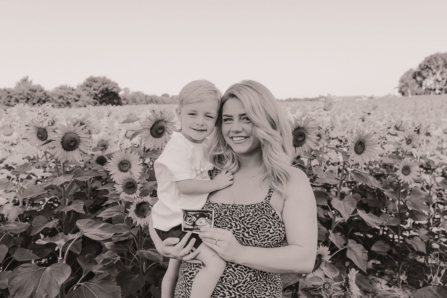 Mother and child pose together in a beautiful sunflower field.  Photographer. Hull. East Yorkshire. Photography
