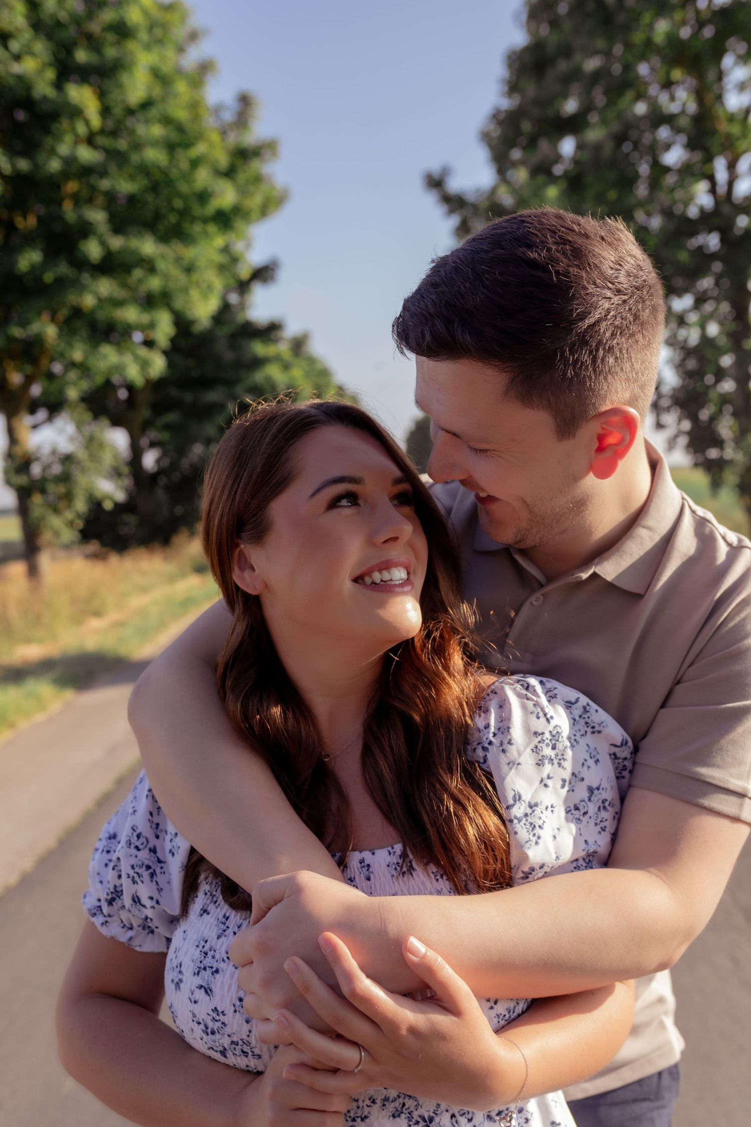 Couple sharing an intimate moment on a tree-lined path during golden hour. Photographer. Hull. East Yorkshire. Photography