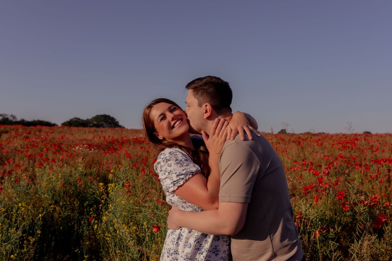 Couple embracing in a vibrant red poppy field during sunset. Photographer. Hull. East Yorkshire. Photography
