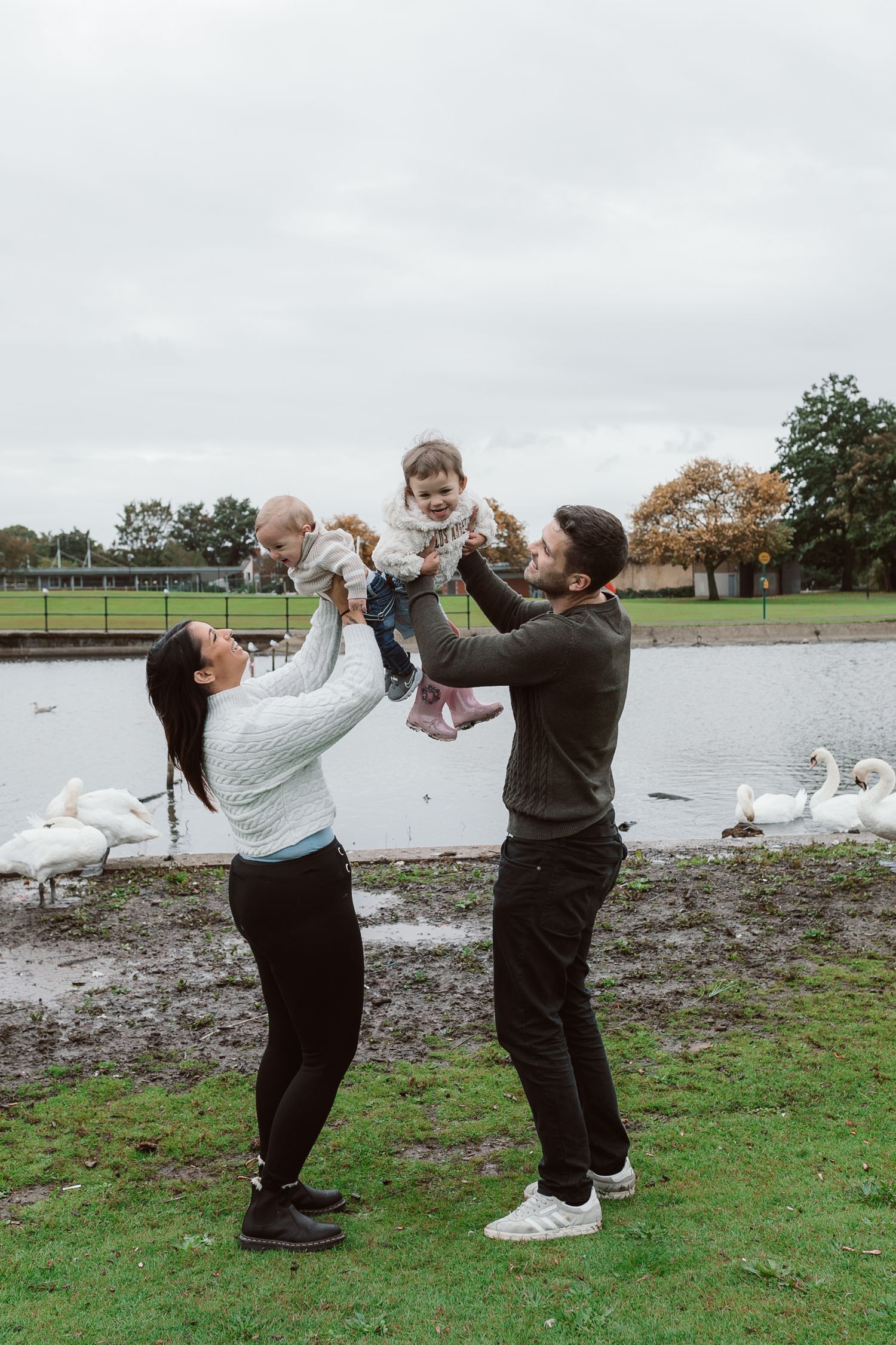 Family playing and having fun together by a lake on an overcast autumn day. Photographer. Hull. East Yorkshire. Photography