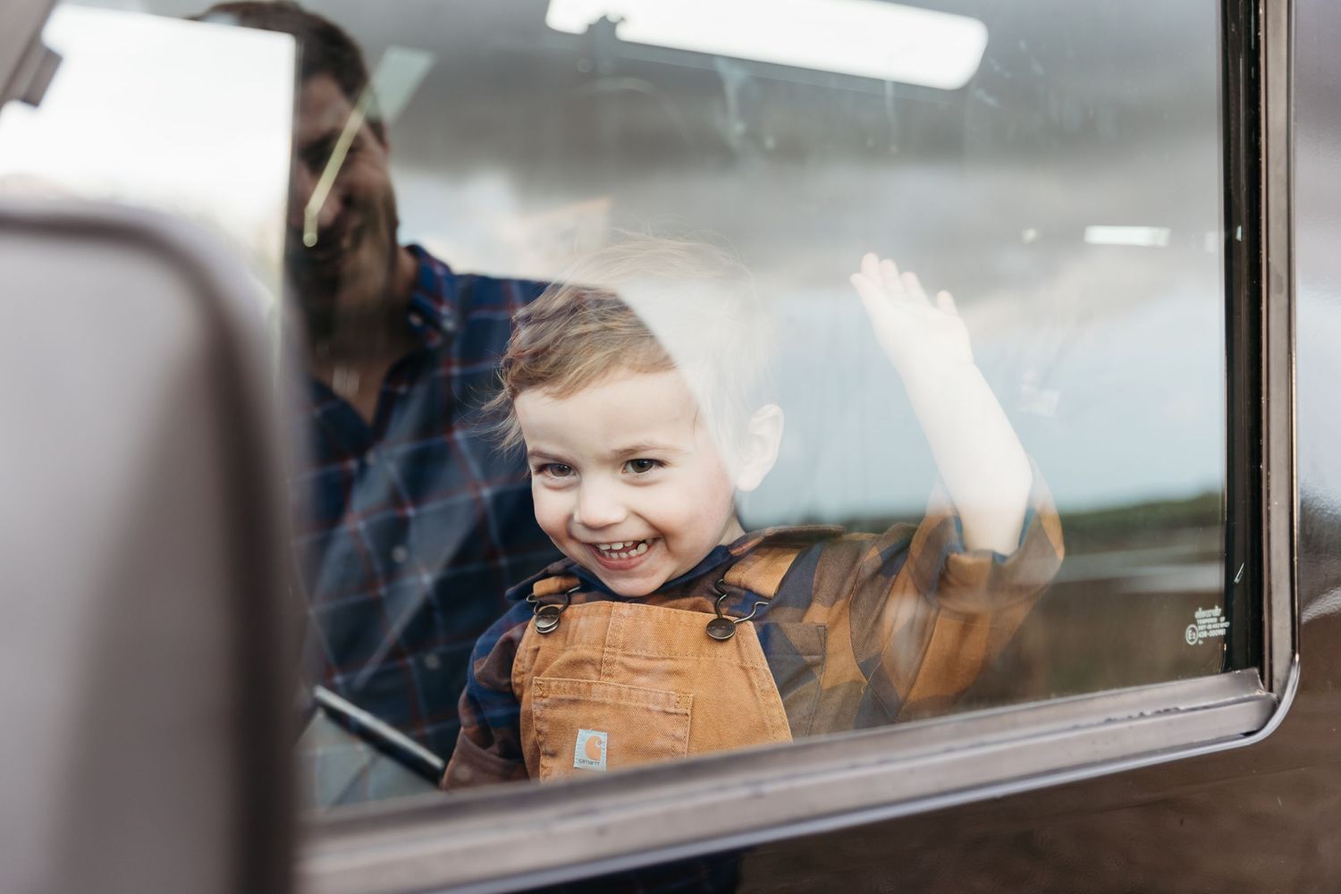 Looking through a car window at playful expressions during a family outing. Photographer. Hull. East Yorkshire. Photography