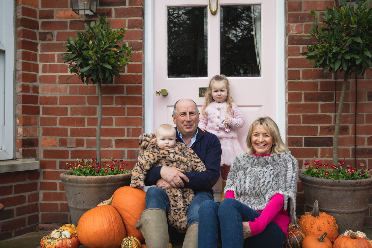 Autumn scene with pumpkins and decorative plants arranged on brick steps by a front door. Photographer. Hull. East Yorkshire. Photography
