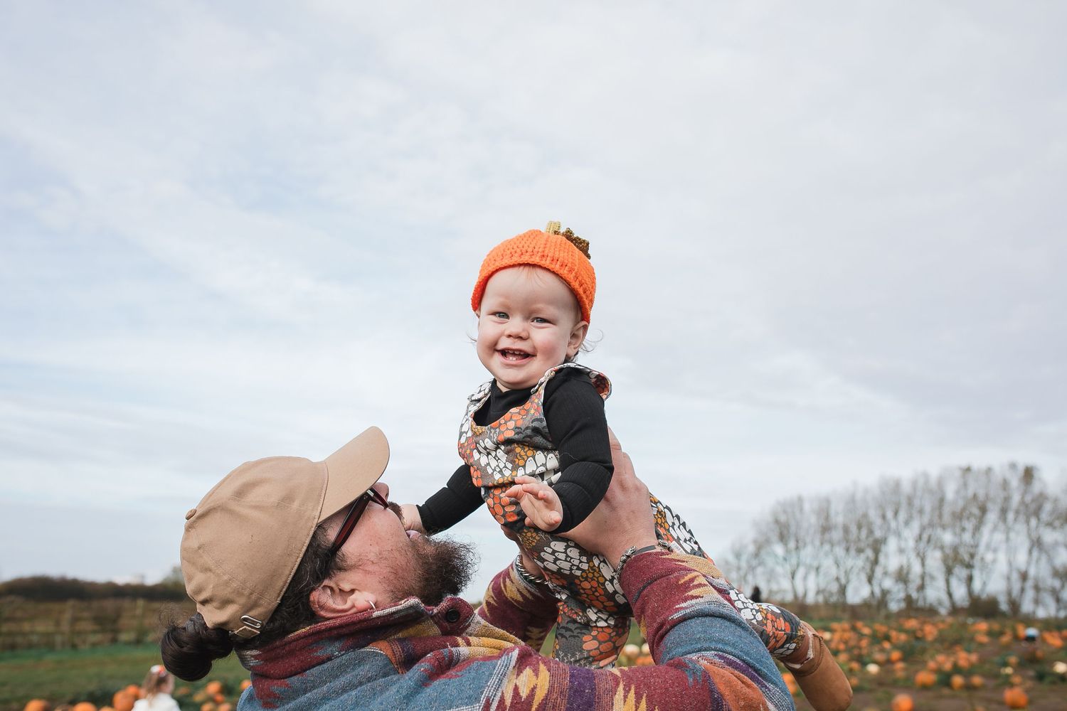 Candid family moments captured against cloudy sky at pumpkin patch. Photographer. Hull. East Yorkshire. Photography