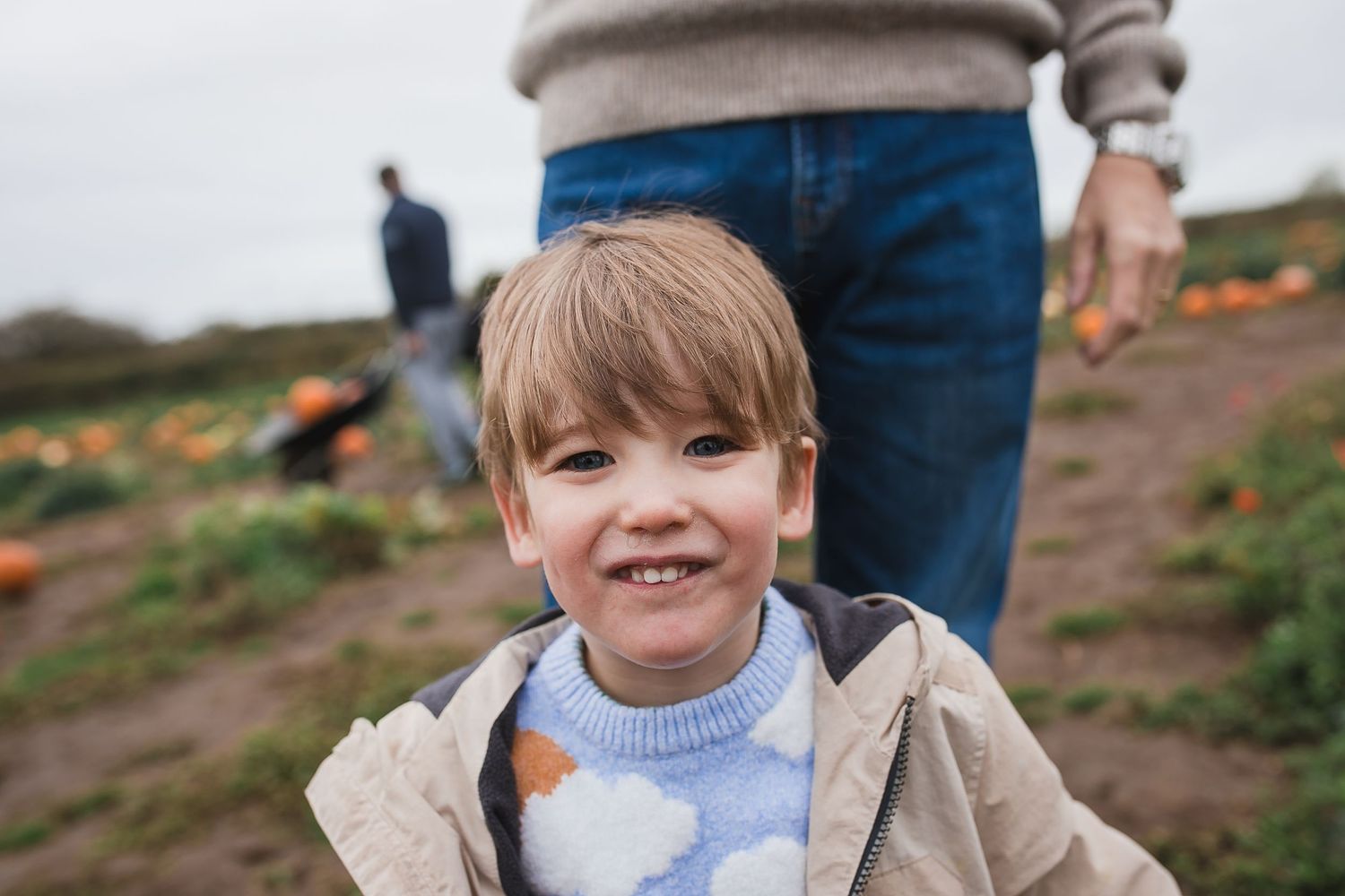 Child smiles while playing outdoors in casual clothing on cloudy autumn day. Photographer. Hull. East Yorkshire. Photography