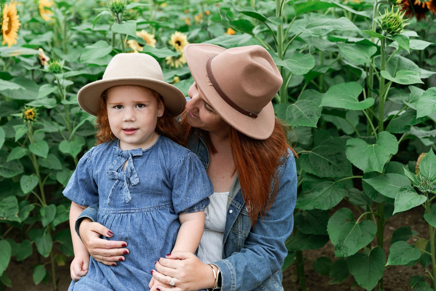Candid family moments captured among tall blooming sunflowers.  Photographer. Hull. East Yorkshire. Photography
