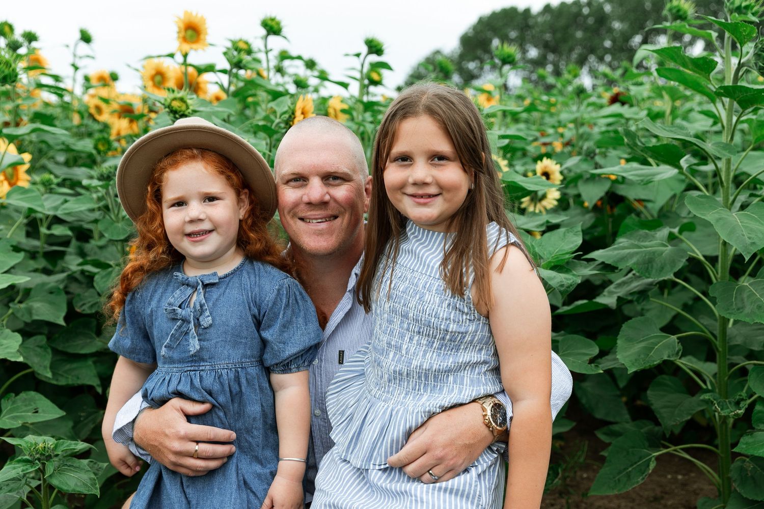 Happy family portraits taken in a field of bright yellow sunflowers. Photographer. Hull. East Yorkshire. Photography
