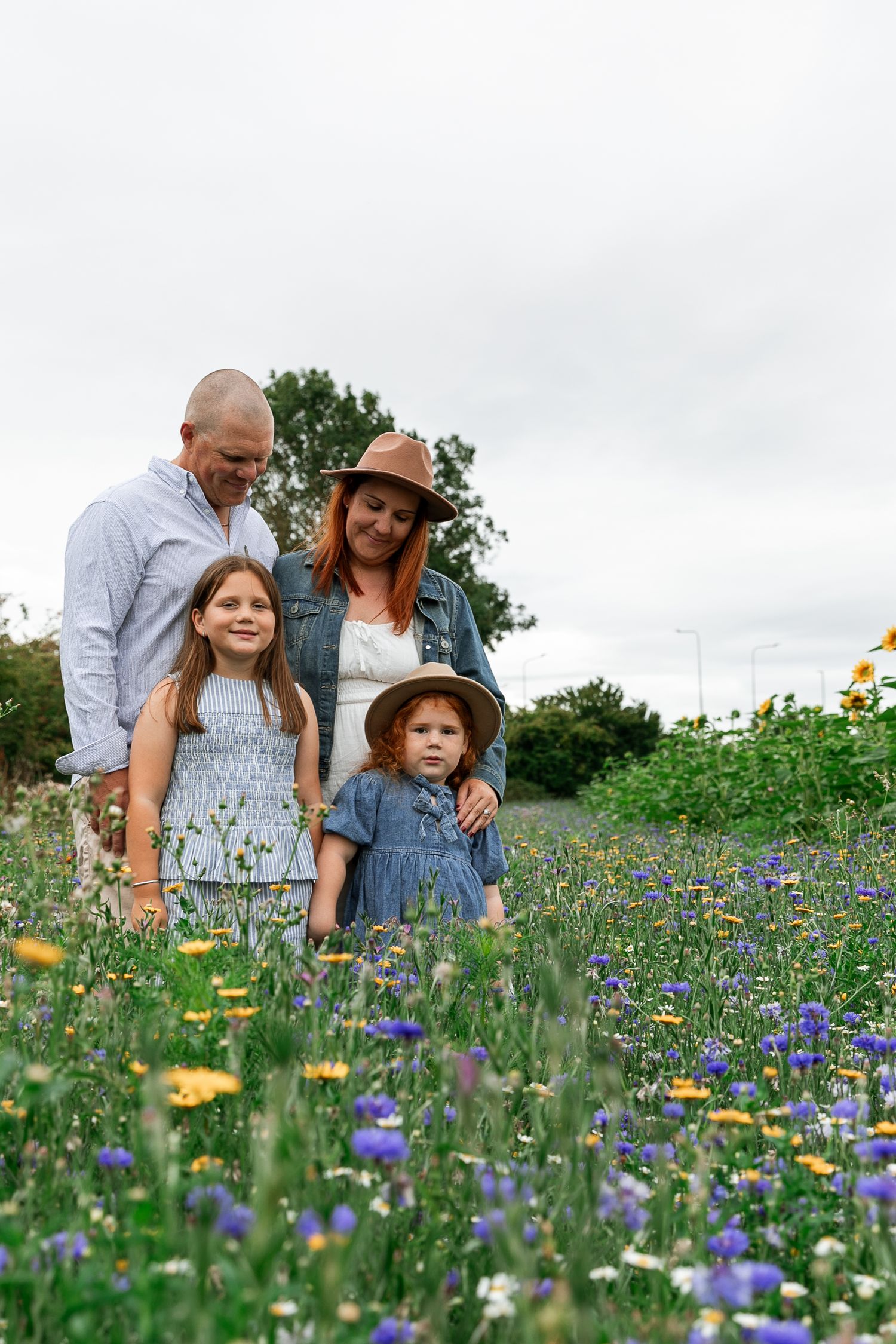 Family enjoying time together in a field of colourful wildflowers and blue bonnets.  Photographer. Hull. East Yorkshire. Photography