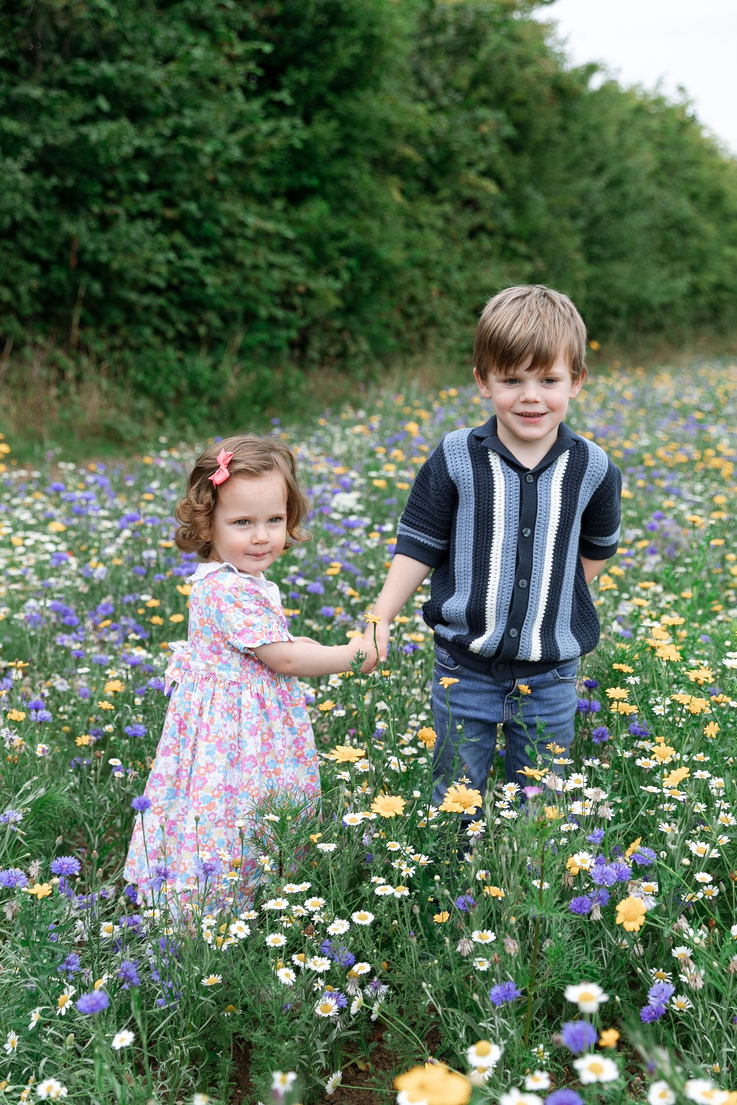Children playing among colourful wildflowers in a summer meadow.  Photographer. Hull. East Yorkshire. Photography