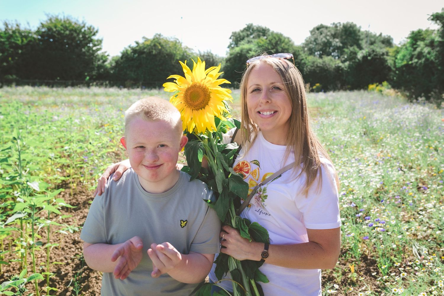 Joyful summer portrait with giant sunflowers in a wildflower meadow. Photographer. Hull. East Yorkshire. Photography