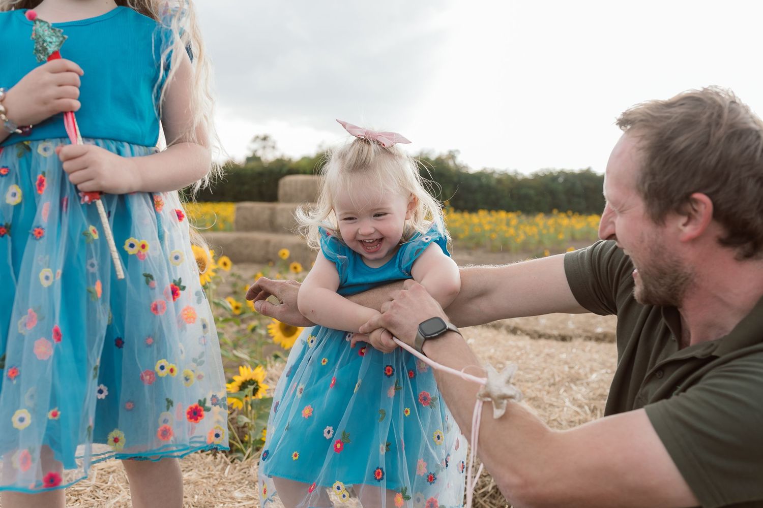 Sweet family moment among sunflowers in a field on a sunny afternoon. Photographer. Hull. East Yorkshire. Photography