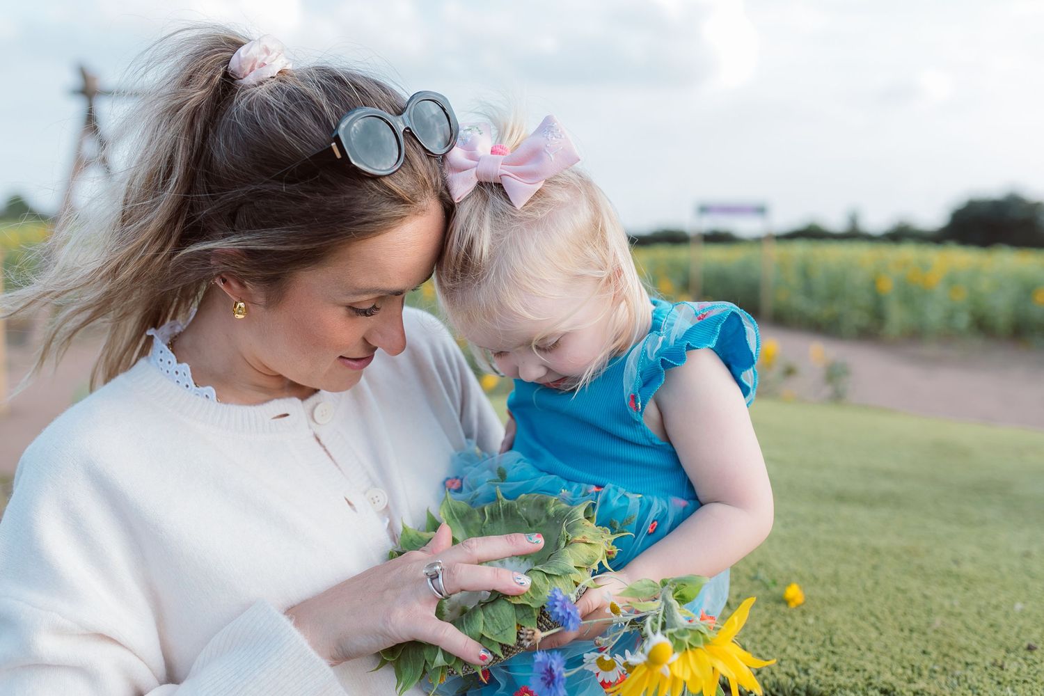 Mother and child exploring sunflowers together in a sunny field during golden hour. Photographer. Hull. East Yorkshire. Photography