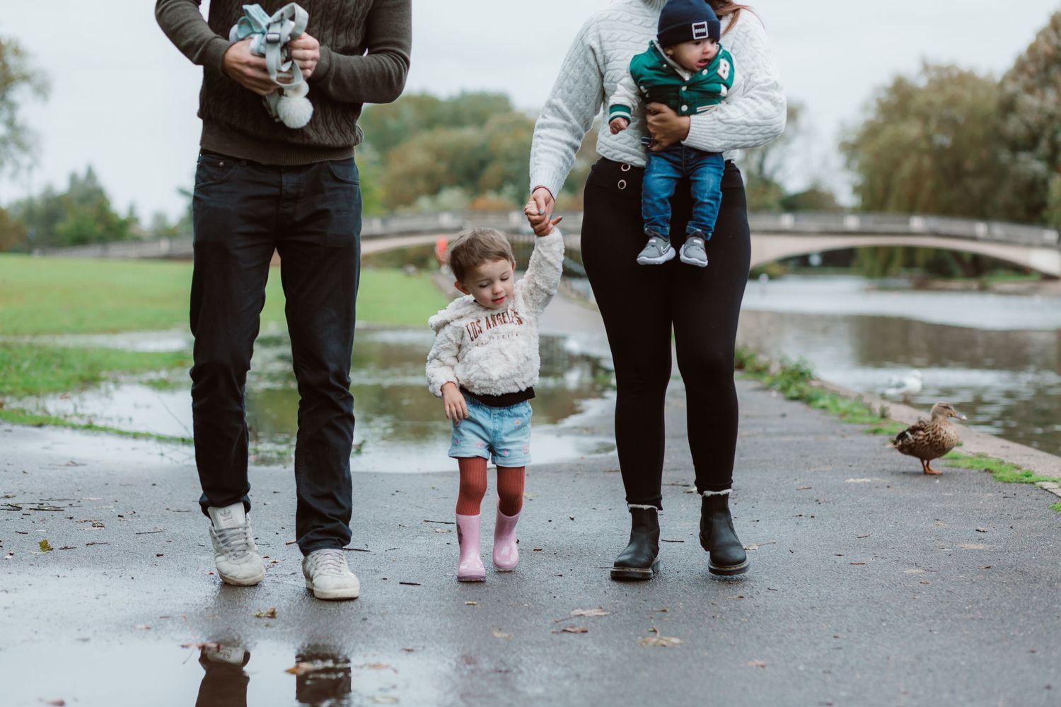 Family walking together on a wet path near a pond during autumn. Photographer. Hull. East Yorkshire. Photography