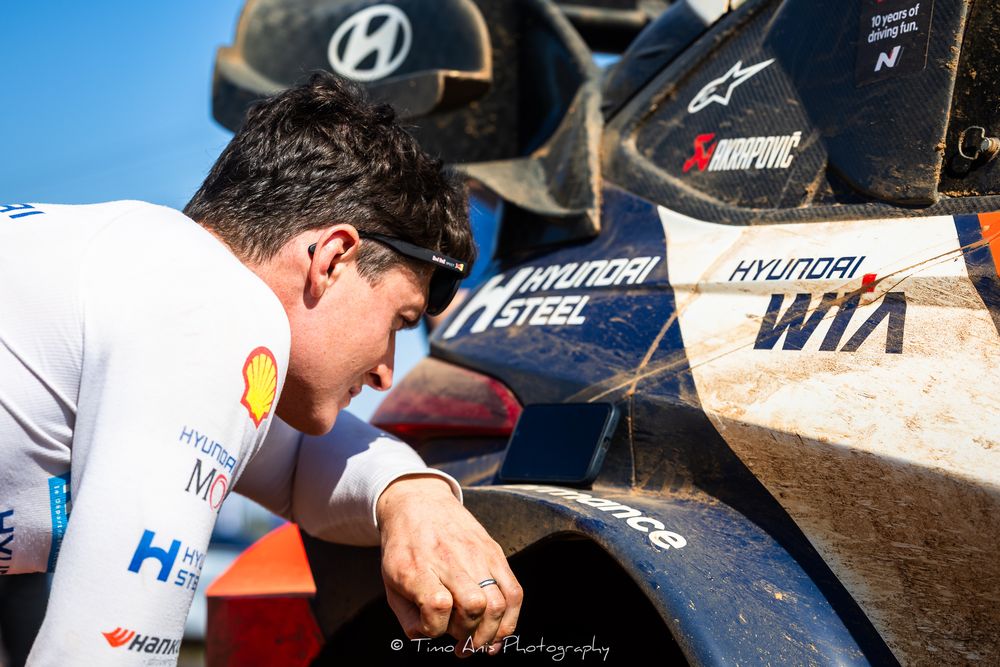 Close-up view of a Hyundai logo and racing team preparations during a motorsport event.