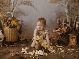A rustic autumn scene with dried flowers, lanterns, and baskets creating a cozy indoor setting.