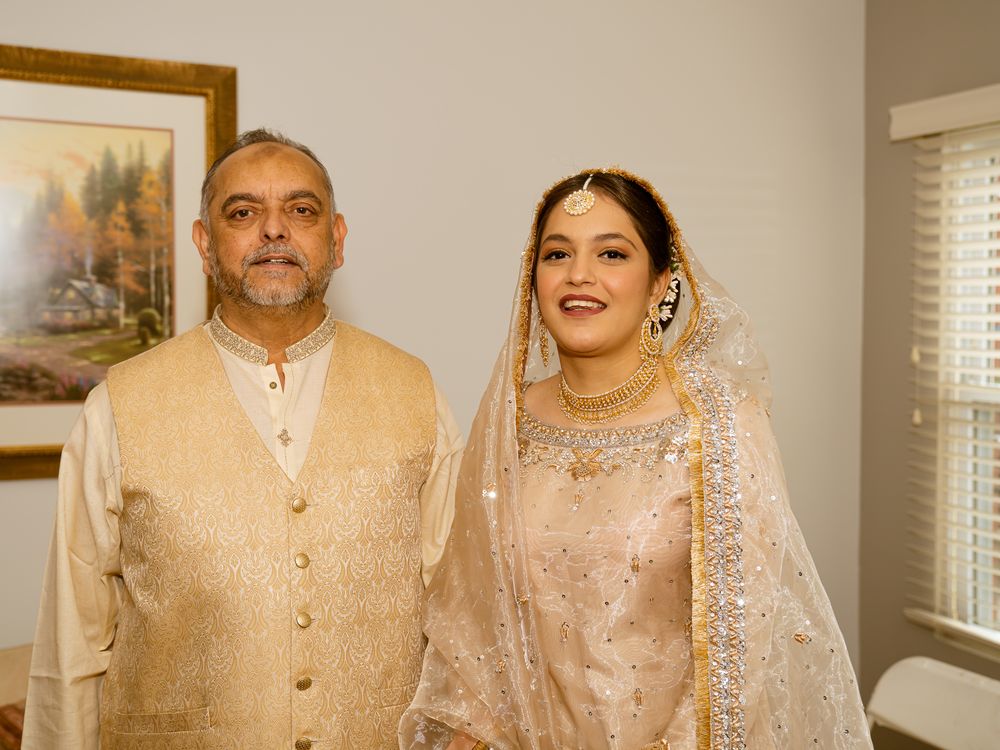 Traditional South Asian wedding attire showcased in formal portrait setting.