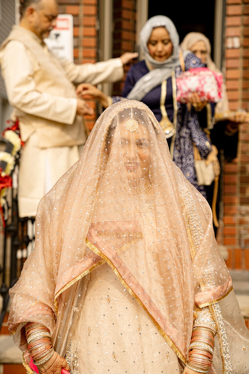 Wedding ceremony scene with traditional South Asian bridal attire and customs.