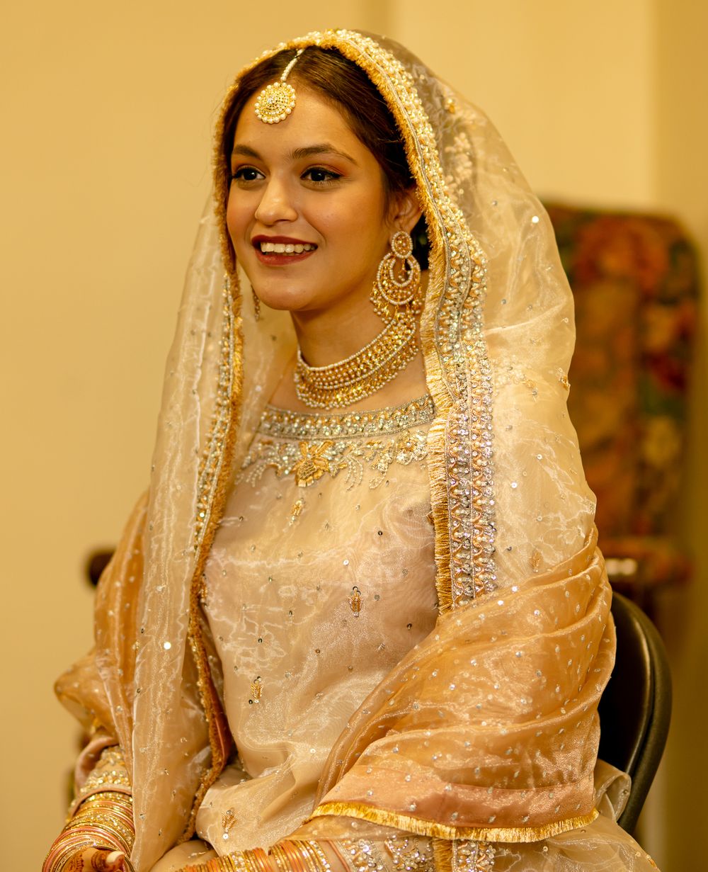 Close-up shots of bride in traditional South Asian wedding attire with intricate jewelry and veil.