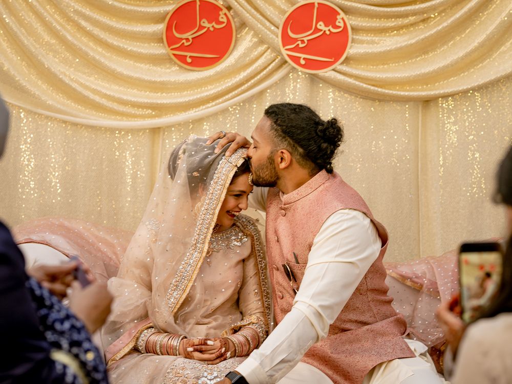Wedding ceremony setup with draped fabric backdrop and red circular decorations.