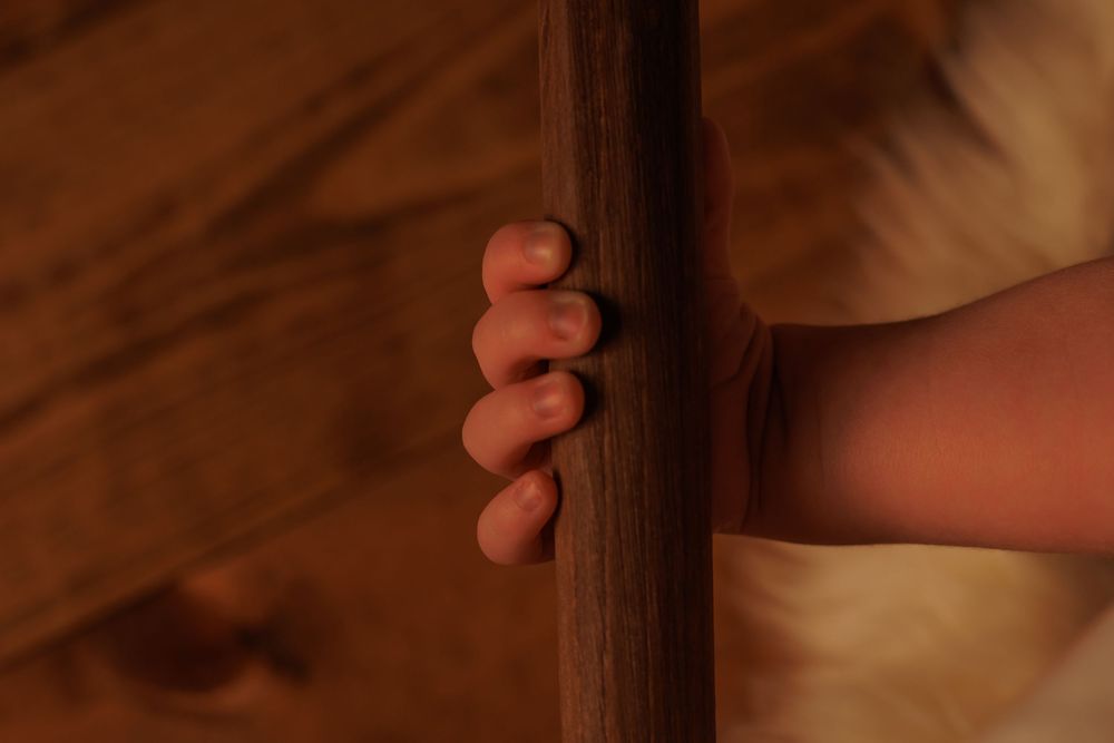 Close up of small baby feet against wooden backdrop.