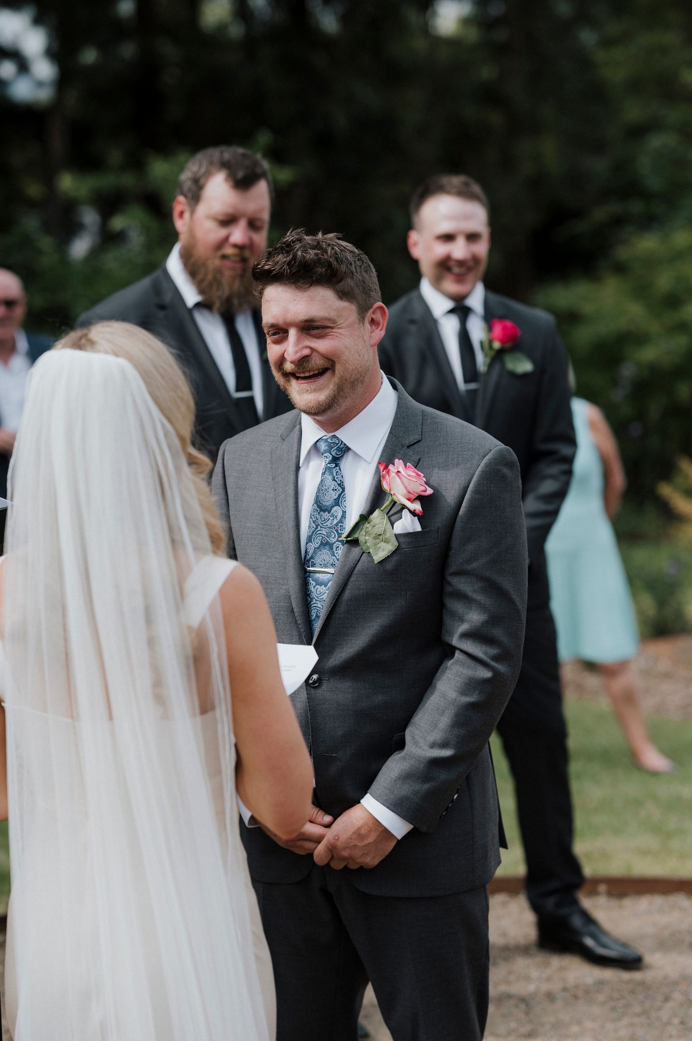 First look wedding moment captured between bride and groom at outdoor garden ceremony.