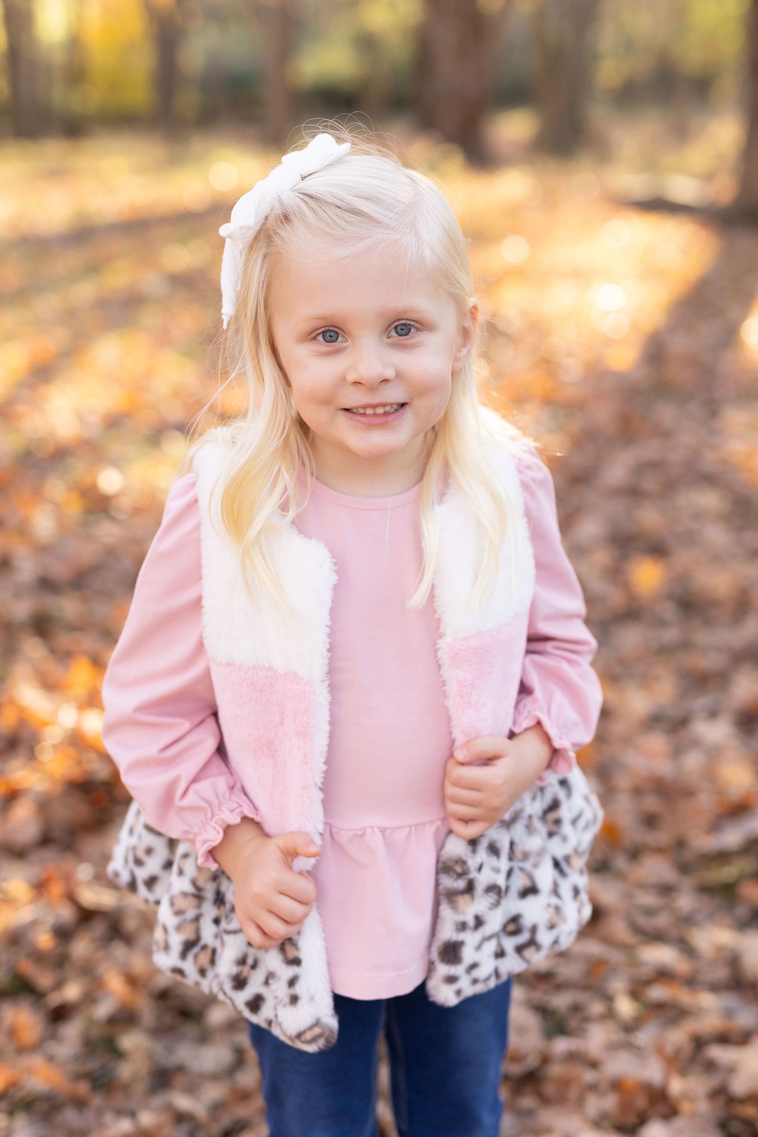 Young girl smiling at a fall family session