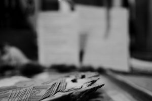 Close-up black and white shot of playing cards on a table.