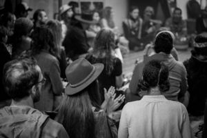 Black and white shot of an audience watching and participating in an event.