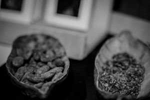 Close-up black and white macro photograph of herb-filled bowls.