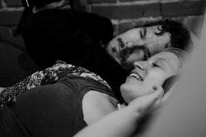 Intimate black and white portrait of couple sharing tender moment.