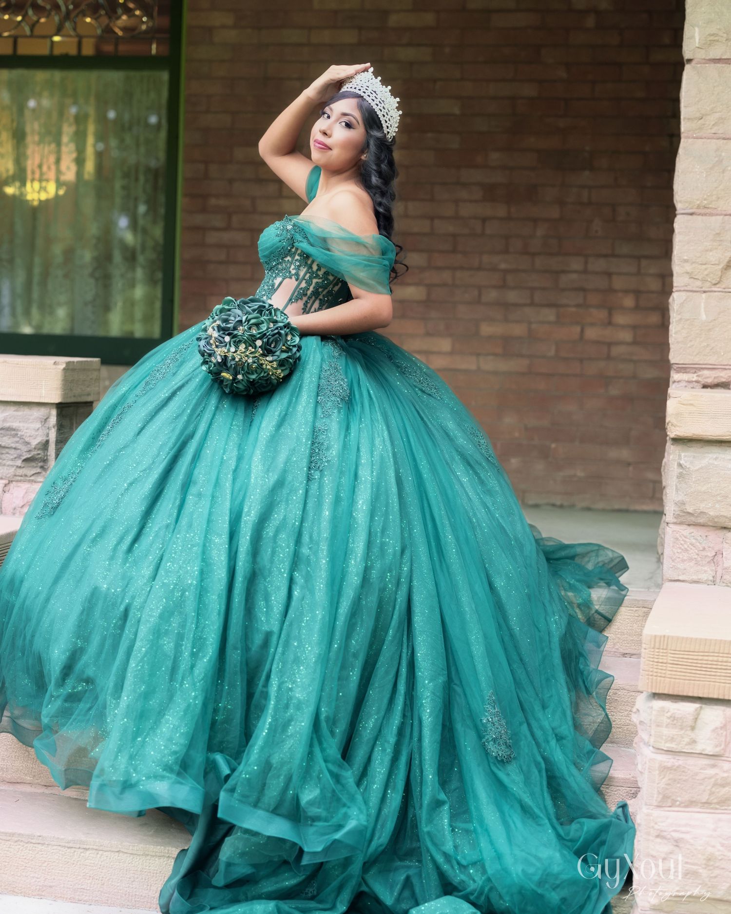 A stunning emerald green ball gown with tulle skirts and off-shoulder design is showcased in multiple angles.