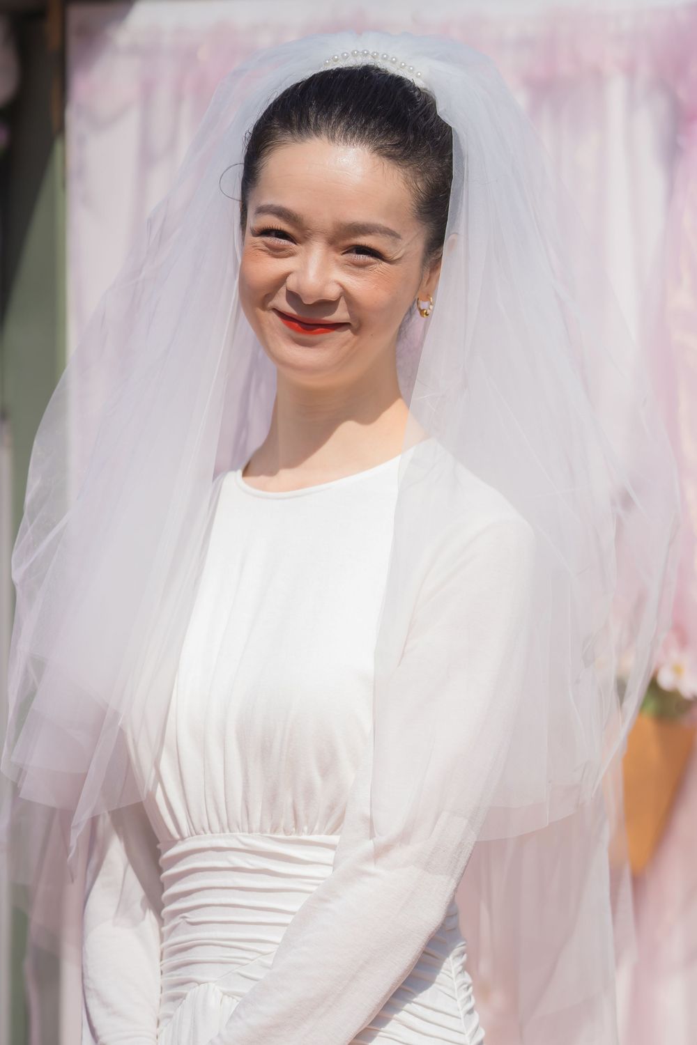 Elegant bridal portrait series showing romantic poses with flowing white veil and simple white wedding dress.
