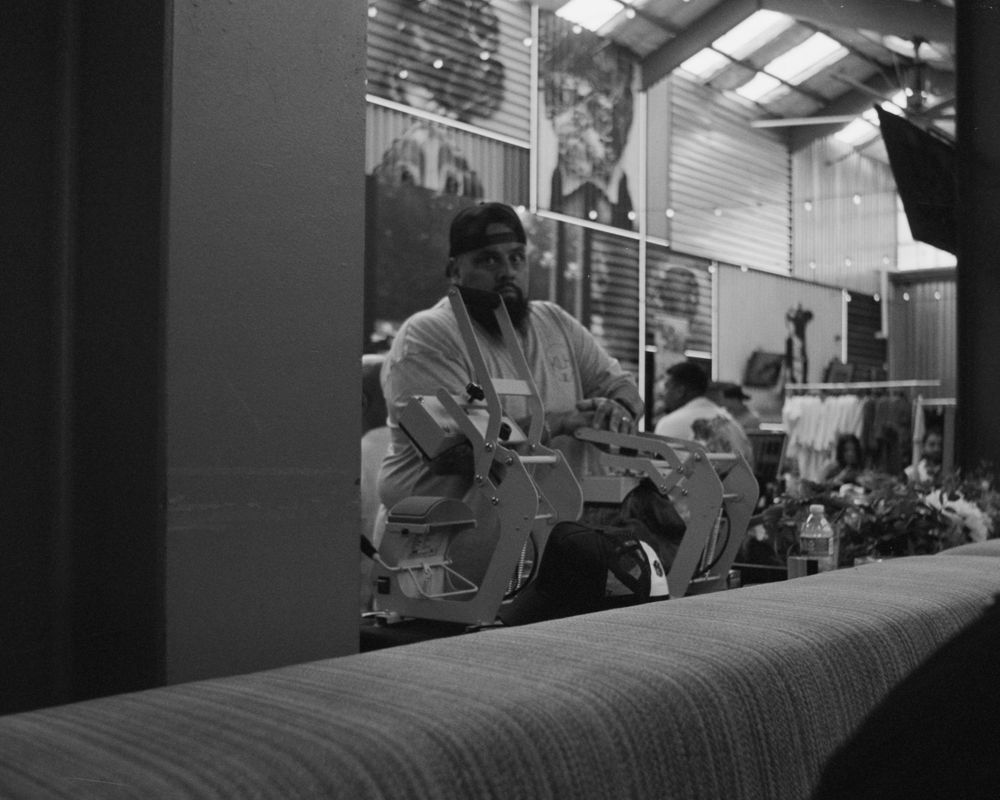 Three musicians perform at a small venue as the audience gathers nearby in a casual indoor setting.