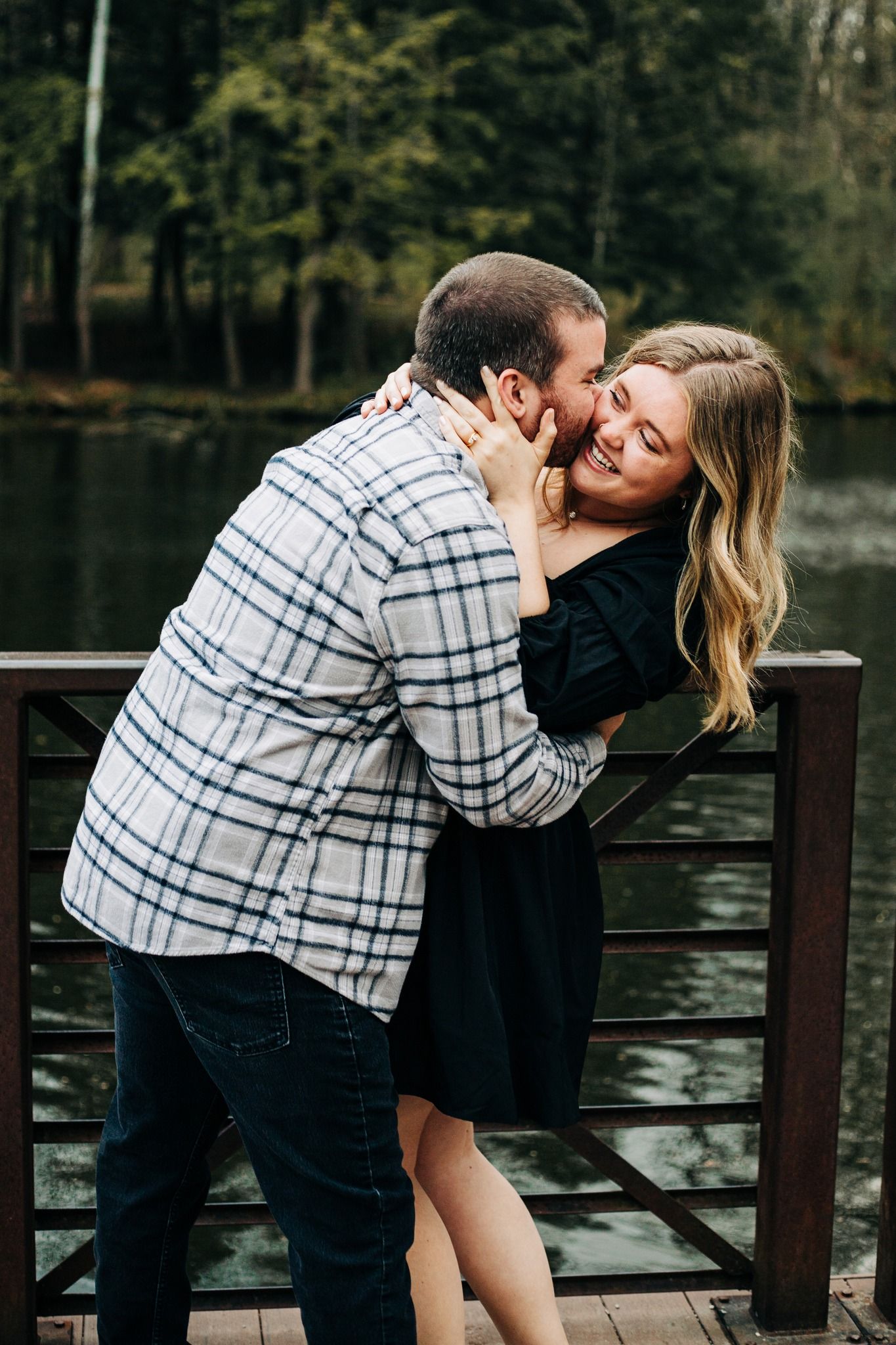 man kisses woman on cheek