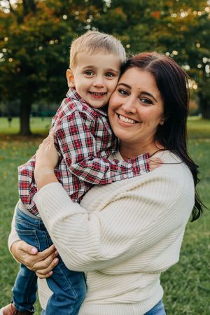 child and mother smile at camera