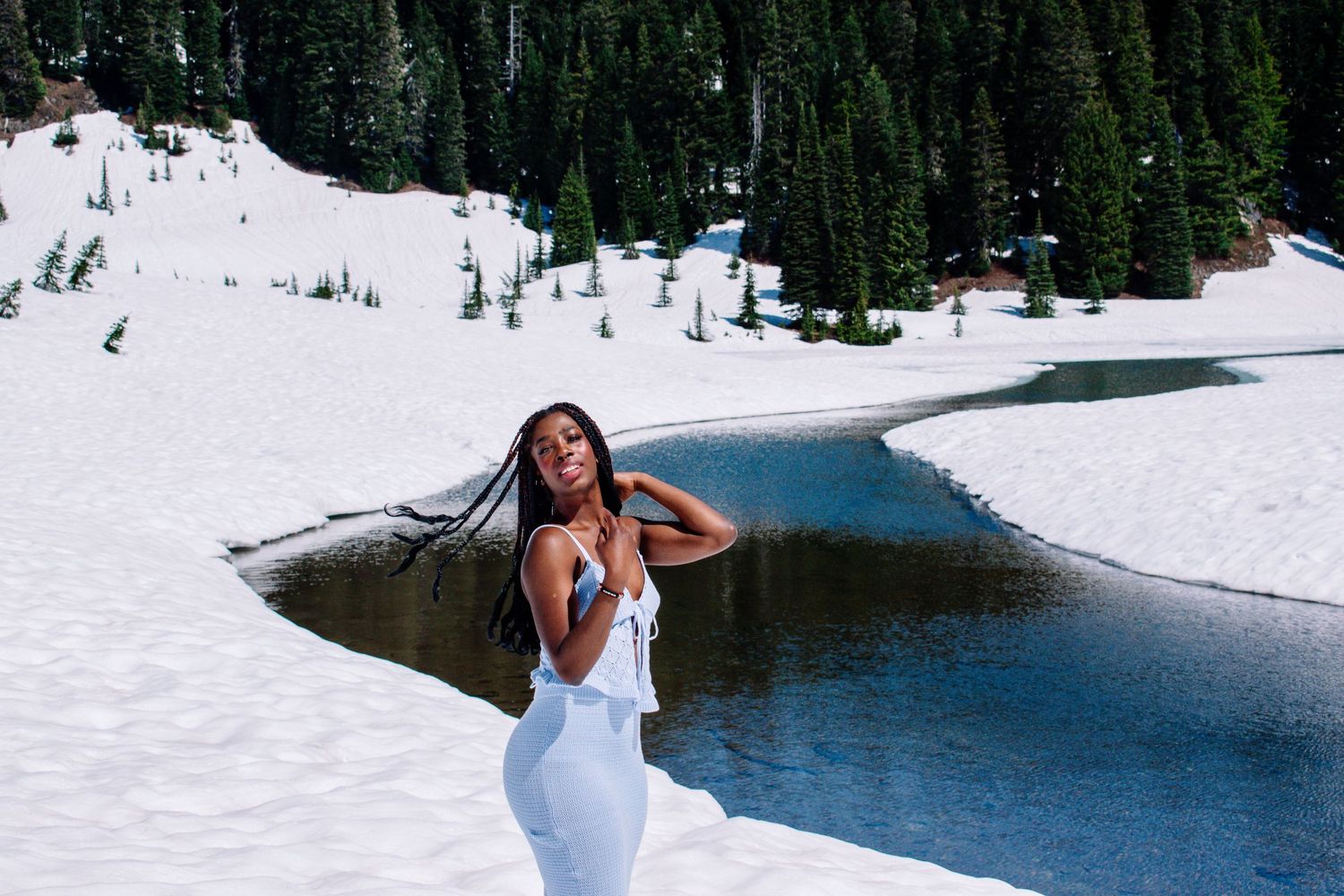 High school senior girl posing in the snow at Naches Loop Trail in a blue dress.