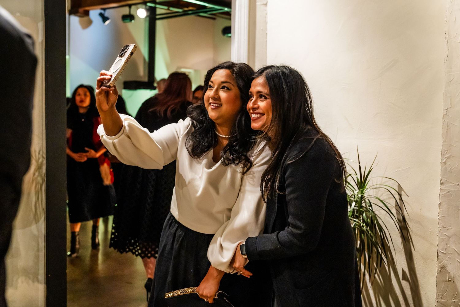 Group of people celebrating and having fun at an indoor social gathering.