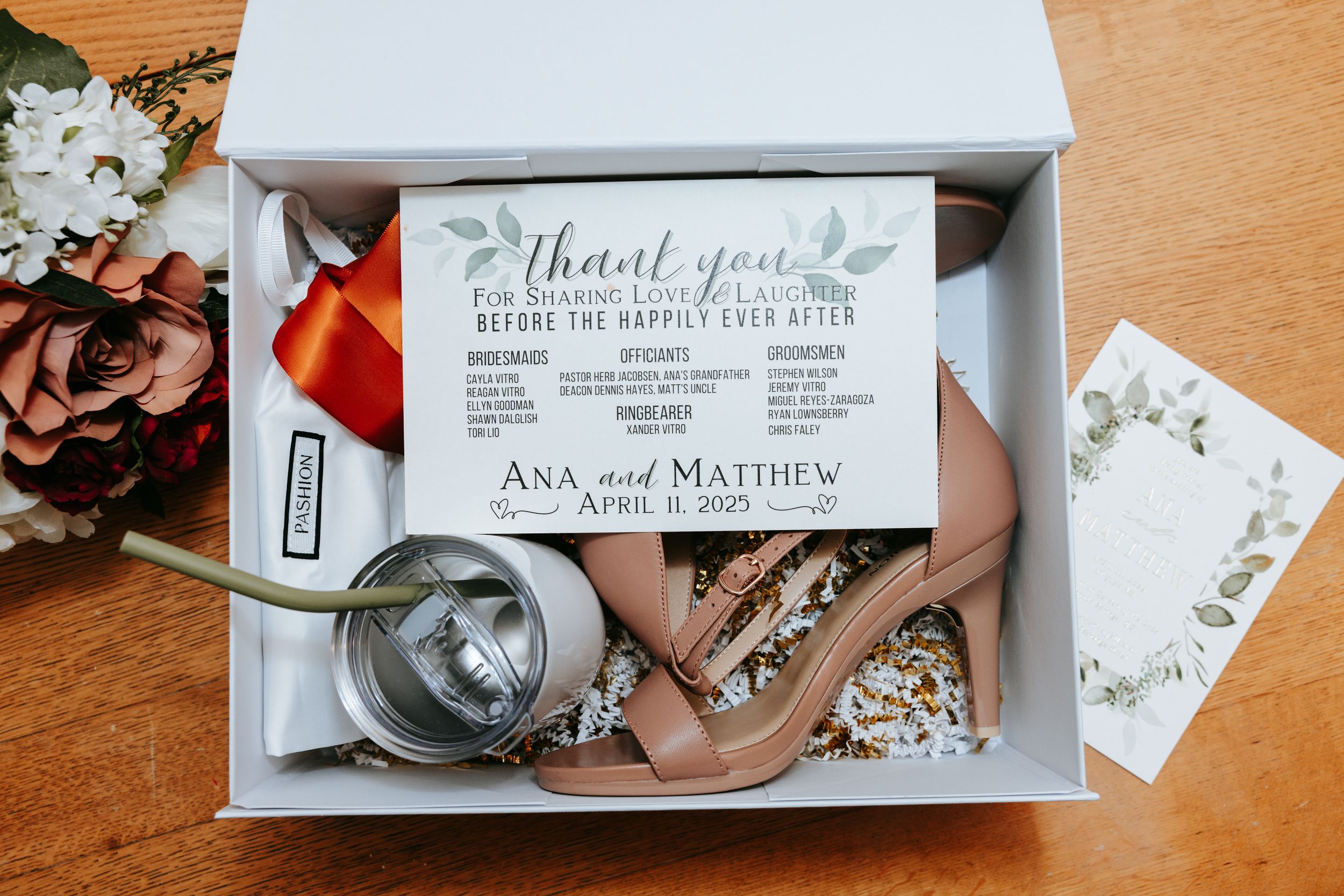 Elegant wedding invitation suite and detail shots displayed on wooden surface.