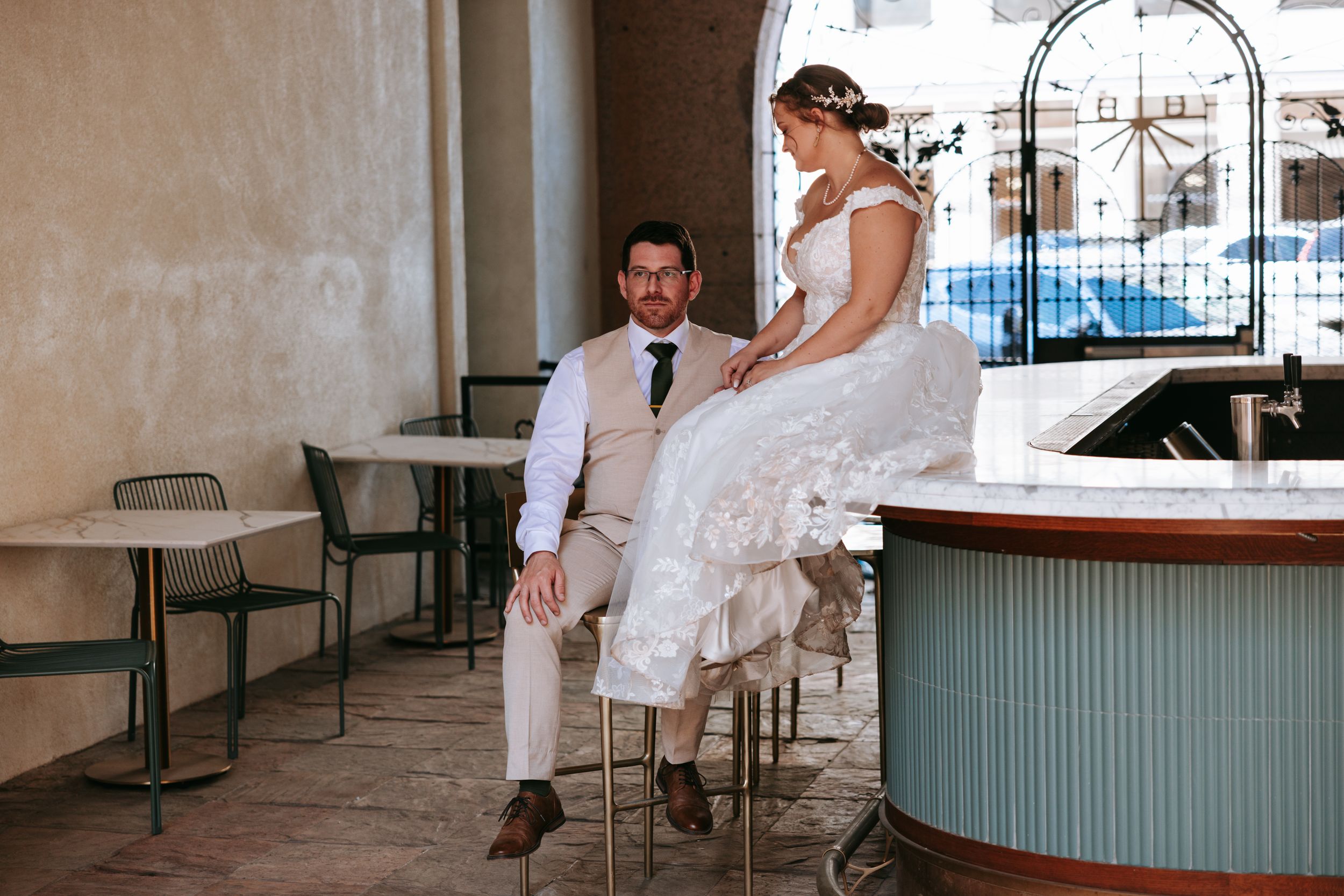 Indoor venue with white walls and teal accents sets the scene for elegant wedding reception.
