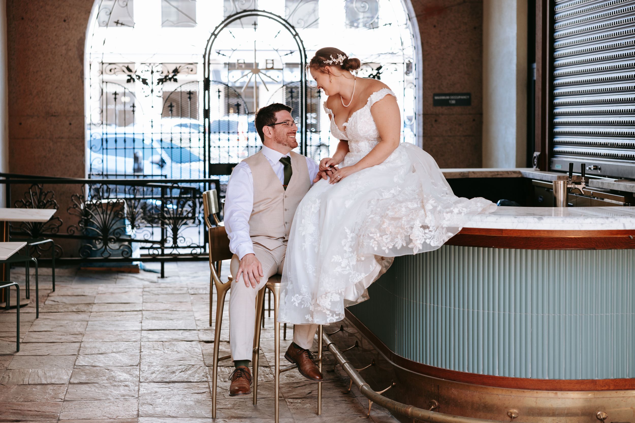 A romantic wedding scene with a couple at a vintage diner counter featuring soft lighting and retro decor.