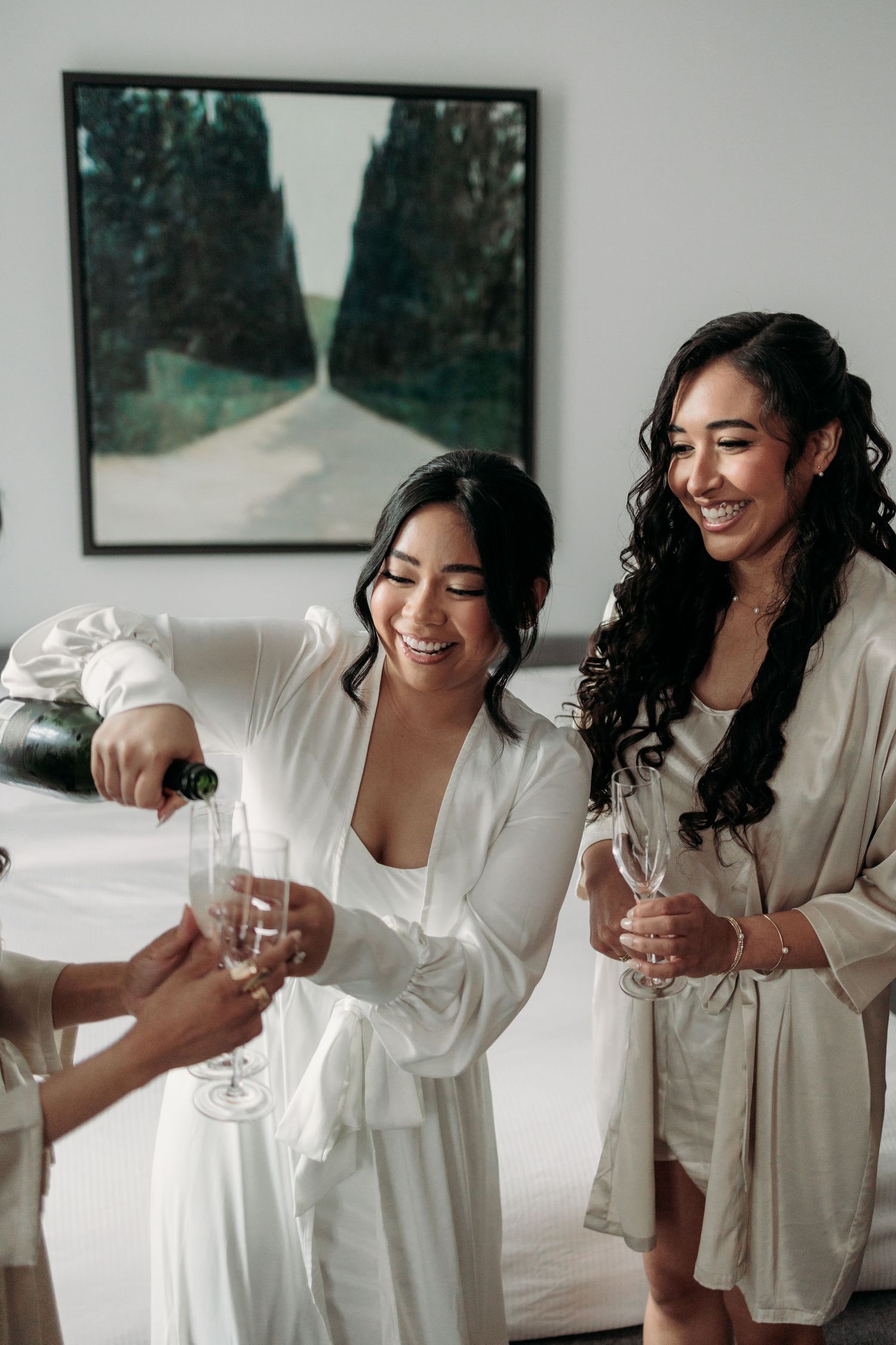 Bride pours her best friends champagne on wedding morning at Hotel Gault. Captured by Montreal wedding photographer, Aliza Dworkind.